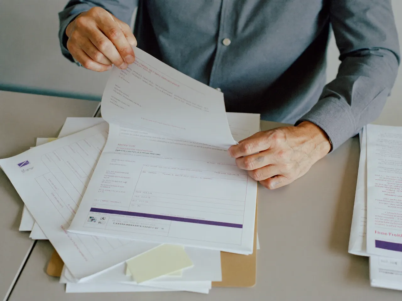 A licensing specialist assembling a state medical license and NPPES application packet