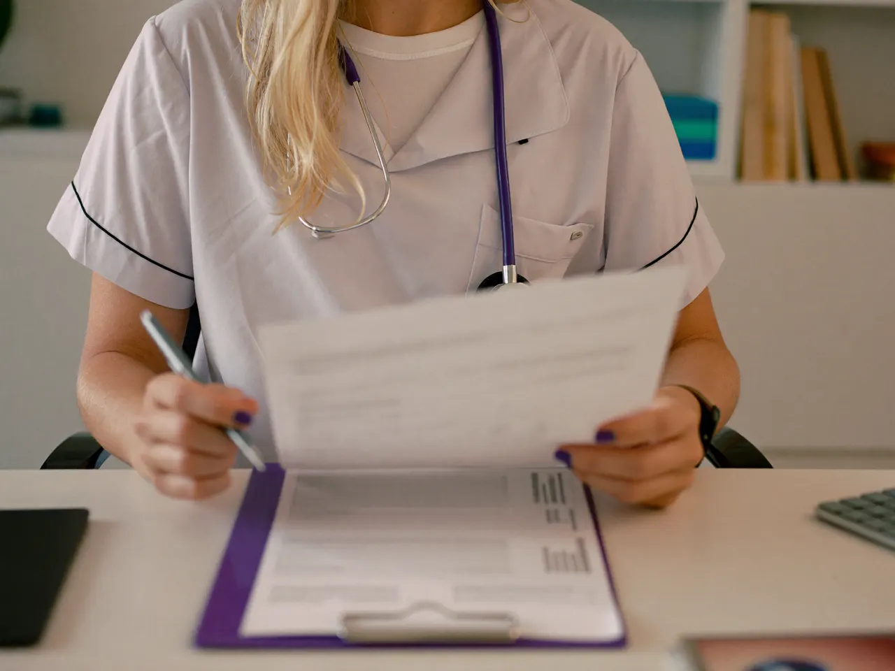 Therapist at a desk reviewing an insurance panel list