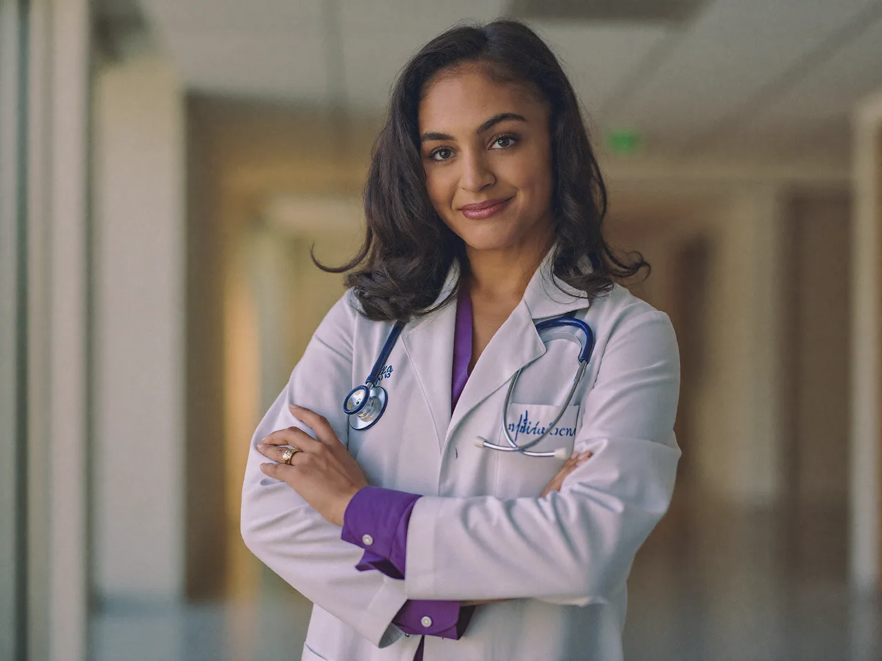 A physician credentialing specialist in a white coat and stethoscope